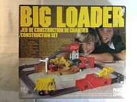 Box front showing the set in play with children on the cover, highlighting functions like loading, scooping, dumping, and motorized track vehicles.