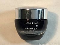 Front side of the Lancome Genifique Repair Youth Activating Night Cream jar showing brand and product name.