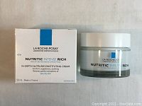 Photo of closed product box and cream jar, showing front labeling and size.