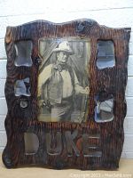 Front view of wooden framed vintage John Wayne picture with four small mirrors and 'DUKE' carved on the frame bottom.
