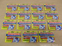 Photo showing all 15 unopened packs of 1988 Topps Baseball Yearbook Stickercards laid out side by side on a flat surface.