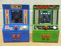 Front view of Mrs. Pac-Man and Frogger classic mini arcade games showcasing screen, joysticks, buttons and color schemes.