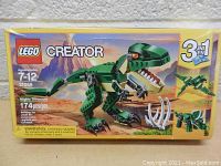Front view of Lego Creator 3-in-1 Mighty Dinosaurs set 31058 box showcasing green T-Rex and alternative builds