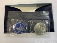 Silver 1971 Eisenhower uncirculated dollar coin sealed in transparent plastic pouch with label indicating 40% silver.