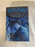 Front cover of the Harry Potter and the Order of the Phoenix hardcover book with dust jacket showing Harry Potter illustration.