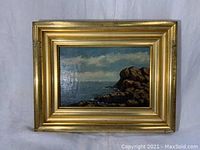 Front view of entire framed marine painting showing seascape and frame