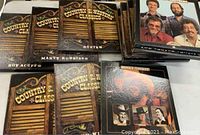 Photo showing a selection of the 14 boxed vinyl record sets with western-themed covers and various artist names visible.