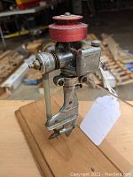 Front-left three-quarter view of model motor showing clamp, flywheel and housing