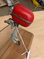 Side angle photo showing the red top casing and the clamp for attachment on the motor shaft.