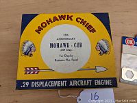 Original Mohawk Chief 25th Anniversary .049 displacement model engine box with colorful yellow and blue design and text.