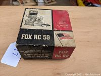 Photo of the original box showing the Fox RC 59 graphics and American flag on the cover, with visible wear.