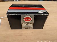 Original black Cox box with red and silver stripes and label showing the product details and number 150.