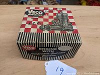 Original Veco Engine box with red and white checkered pattern, black and white striped sides, and engine illustration on top.