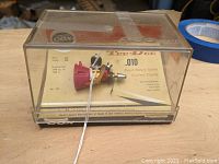 Engine mounted on original cardboard backing inside clear plastic display case
