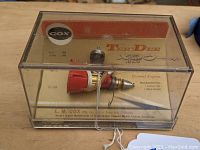 Engine displayed inside original plastic display case with clear view of engine and backing card with brand and specifications.