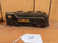 Side view showing 'Commodore Vanderbilt' label, number 1752, black metal construction with rust and wear.