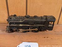 Left side view of the Marx O scale 2-4-2 locomotive showing surface details and condition.