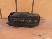 Left side view of black Marx Marlines New York Central train tender with visible logo and text.