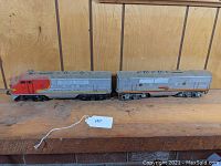 Side view of Lionel Santa Fe diesel engine and tender showing overall condition and paint.