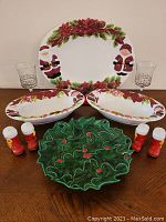 Full set of Christmas serveware including platter, bowls, stemware, and salt and pepper shakers arranged on table