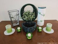 Full lot showing baskets, vases, candleholders and candles arranged on a table