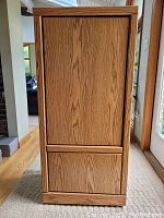Closed view of rolling storage cabinet showing wood grain finish and flat front door panel