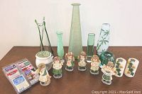 Overview of the lot including six green vases in various shapes and sizes, six mini angels, two candles with ivy decoration, wax melter, and fragrance wax packages.