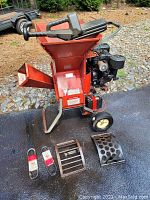 Front-left view showing hopper, engine, wheels, two belts and drums laid out