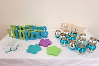 Photo showing all items including LOVE signs in green and blue, clear lace candleholders, silver/aqua candleholders, votive candles, and foam flowers.