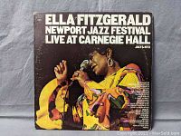 Front cover of Ella Fitzgerald Newport Jazz Festival Live at Carnegie Hall double vinyl album showing Ella singing in colorful dress with microphone