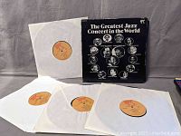 Four original Pablo Records LPs titled 'The Greatest Jazz Concert in the World' with tan and red Pablo labels in white inner sleeves and black outer cover featuring jazz legends portraits and names.