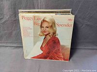 Front view of the Peggy Lee "Big Spender" album showing cover artwork featuring Peggy Lee in a red dress.