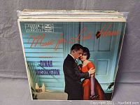 Stack of older jazz vinyl albums with Dinah Washington album on top, titled 'Music for Late Hours' with couple embracing on cover.