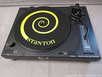 Front angle of the quartz direct drive turntable with Stanton slipmat showing buttons and pitch control slider.