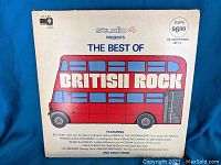 Front of gatefold sleeve showing 'The Best of British Rock' title with red British double-decker bus artwork and track listing of featured artists.