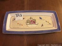 Full view of Wedgwood Queen's Ware 'Sarah's Garden' platter with botanical and butterfly details and purple border, showing size proportions.