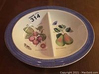 Full view of oval Wedgwood divided server with blue rim and botanical pattern inside showing divided sections.