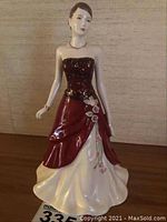 Front view of the porcelain figurine showing full gown and posture