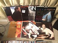 Photo of multiple Frank Sinatra 33rpm vinyl records with album covers and a magazine article visible.