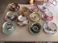 Overhead view of ten teacup and saucer sets arranged in two rows
