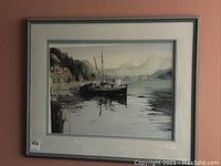 Framed art print featuring a boat on water with forested and mountainous background