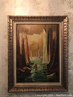 Full view of the original oil painting of sailboats in an ornate wooden frame.
