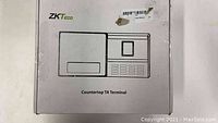 White retail box for ZKTeco Countertop TA Terminal with product line drawing and branding.