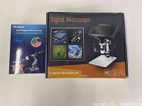 Photo of packaging boxes for Koolertron 7-inch HD digital microscope and Skybasic Wi-Fi digital microscope including Skybasic instruction manual.