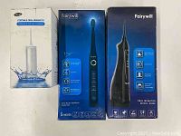 Boxed Glynee portable oral irrigator, Fairywill sonic electric toothbrush model 507 box, and Fairywill oral irrigator model 5020E box showing product images and features
