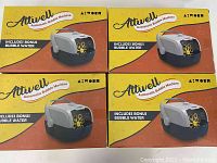 Four boxed Attwell automatic bubble machines showing packaging and labeling, indicating inclusion of bubble water.