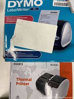 Boxes for DYMO LabelWriter 4XL and MUNBYN Thermal Printer ITPP046 showing branding and model details