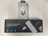 Front view of the iClever wireless keyboard and mouse combo box, showing branding, model IC-GK03, and silver color graphics, alongside the Satechi M1 wireless mouse box showing the mouse image and branding.