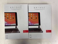 Front of both boxed Brydge wireless keyboard cases showing branding and product image and design for iPad 7th generation 10.2 inch