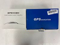 Photo showing Apexcam Car Dash Cam Tour 4 box in white and Lttrbx GPS Navigation blue box side by side.